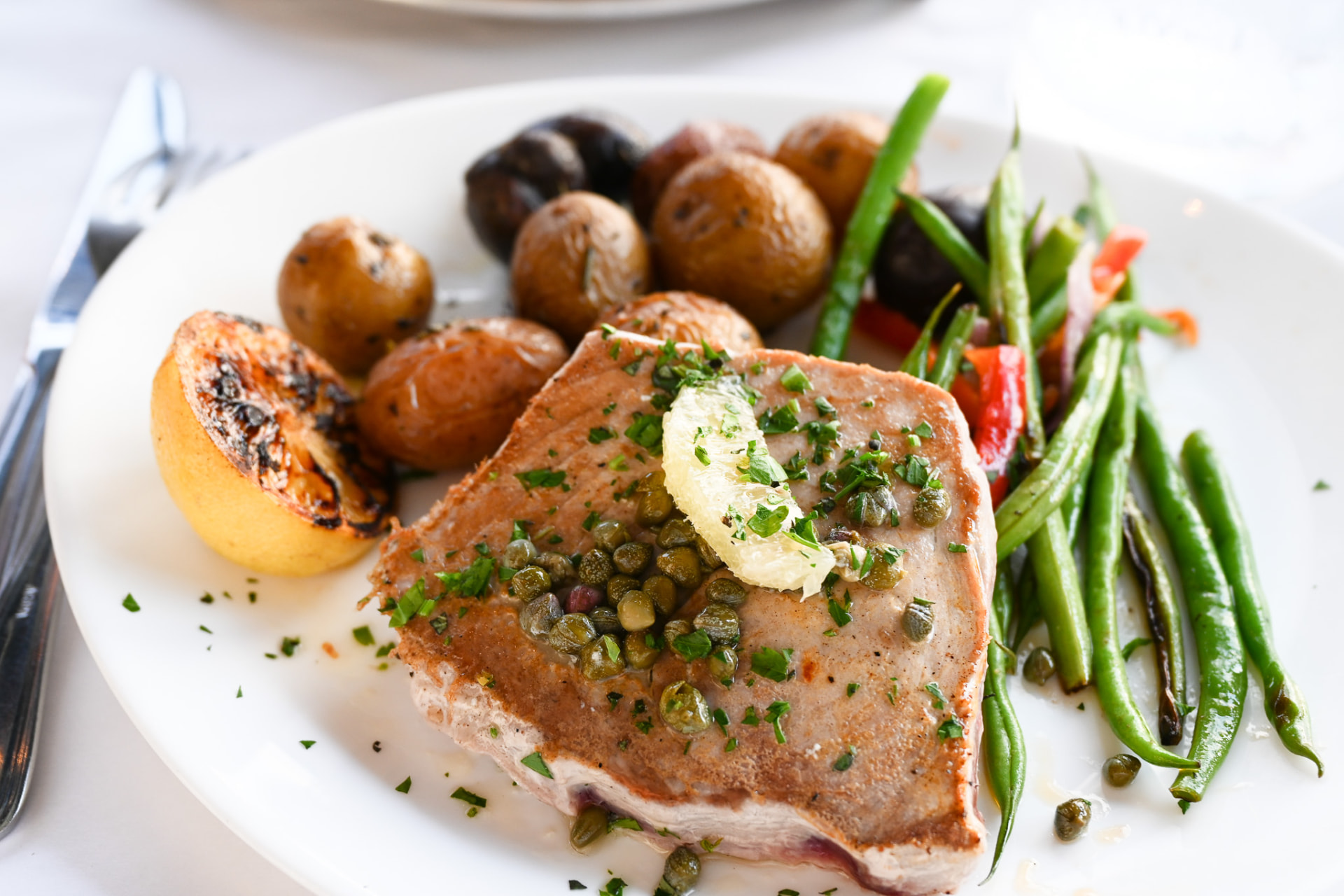 Seared ahi with capers, roasted potatoes and green beans
